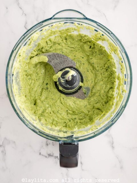 Avocado tomatillo salsa after being blended in a food processor bowl