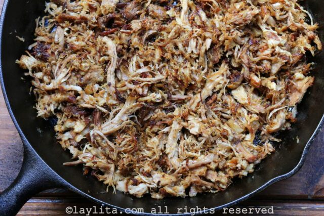 Crispy pulled pork in a black skillet