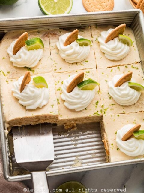 Overhead shot of a carlota de limon in a baking dish with two slices missing