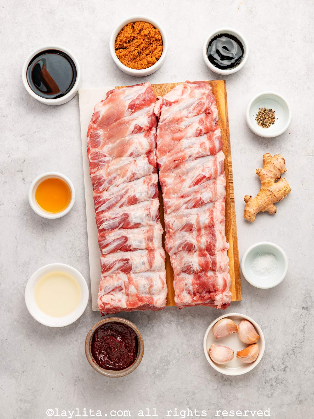 Ingredients needed to make Asian sticky pork ribs on a kitchen counter