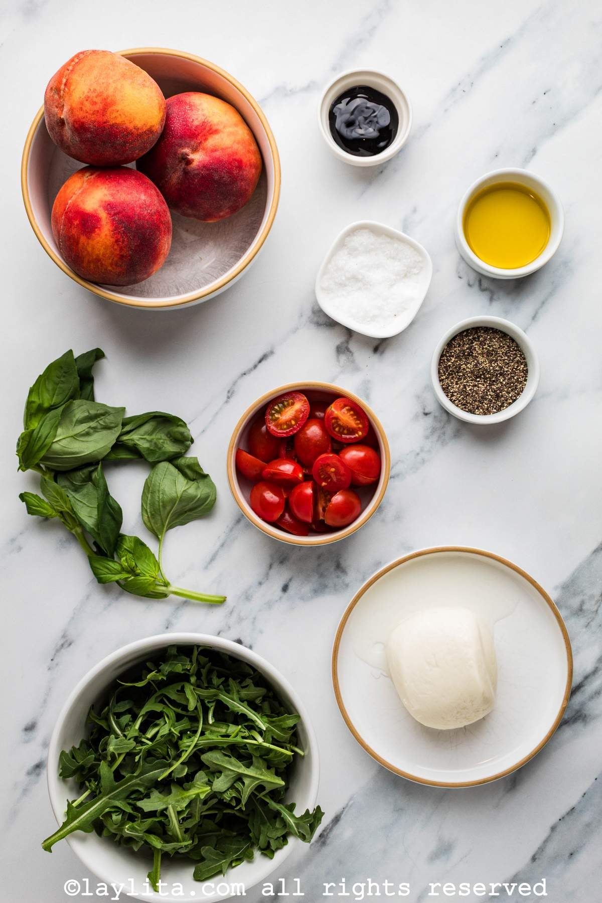 Ingredients for Peach Burrata Salad on a kitchen counter
