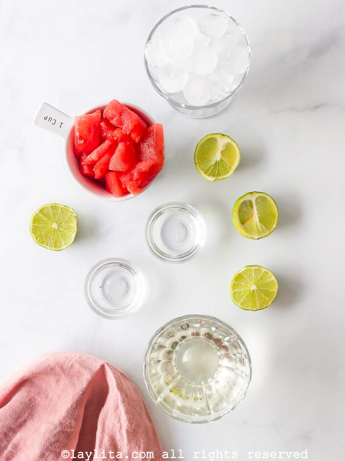 Ingredients needed to make watermelon margaritas on a kitchen counter.