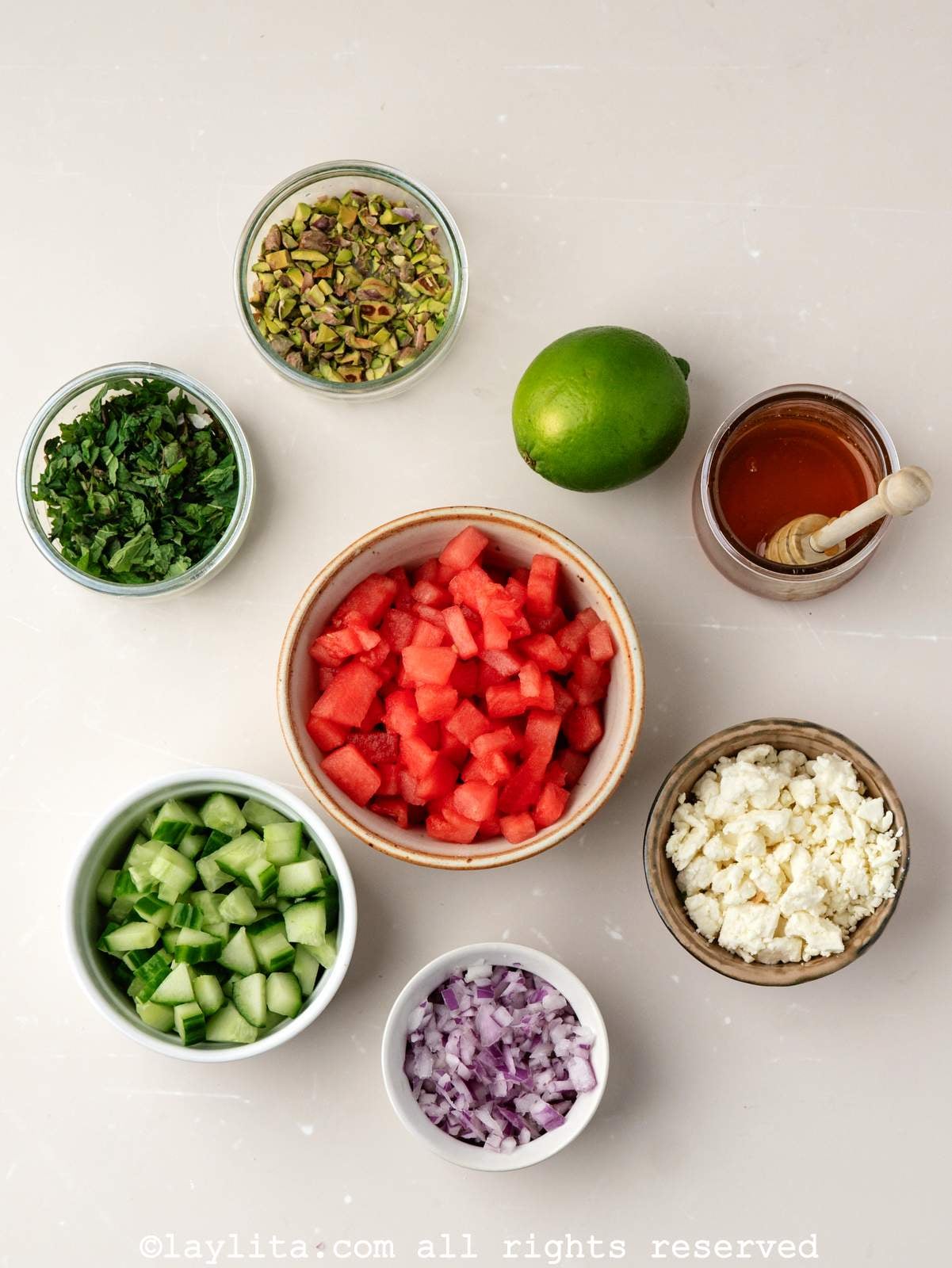 Ingredients for watermelon feta salad with mint on a kitchen counter