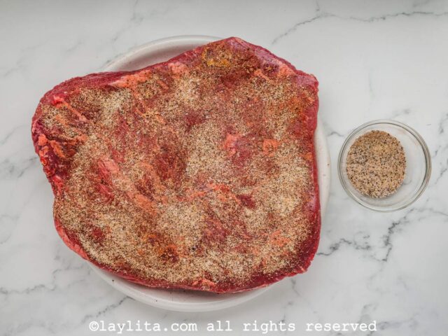 A beef brisket before smoking with seasoning rub