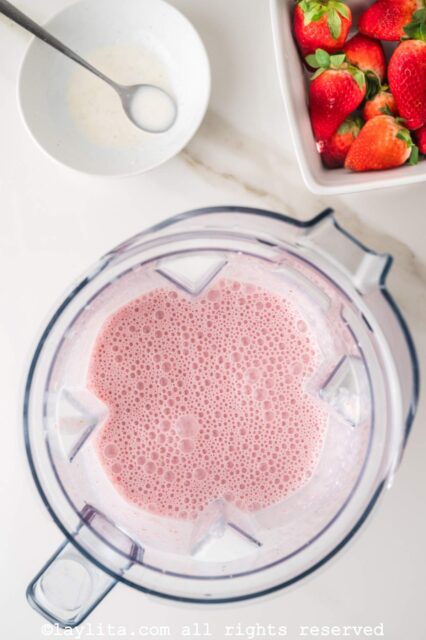 Blended fruit milkshake in a blender