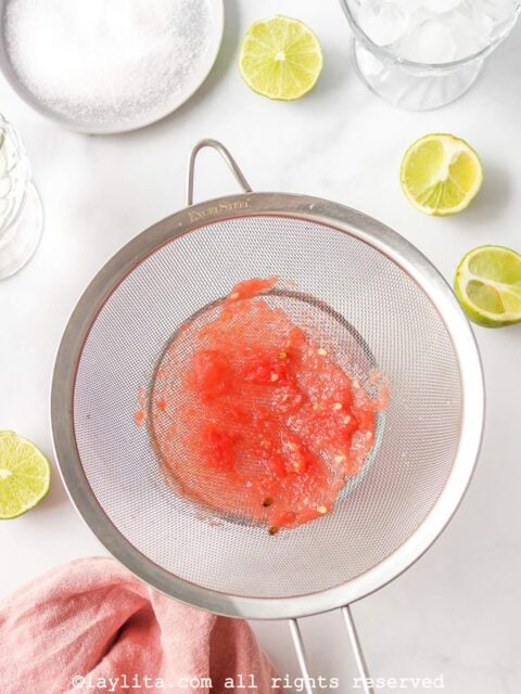Watermelon blended mix being strained