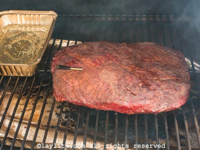 A beef brisket cooking in the smoker grill