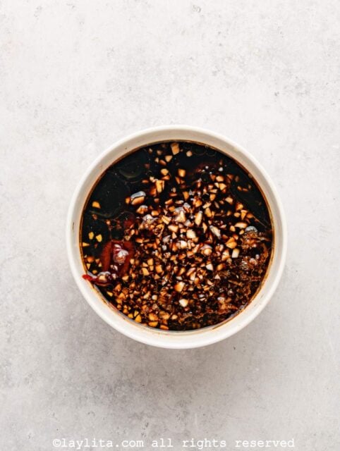 Ingredients for an Asian gochujang hoison sauce in a white bowl