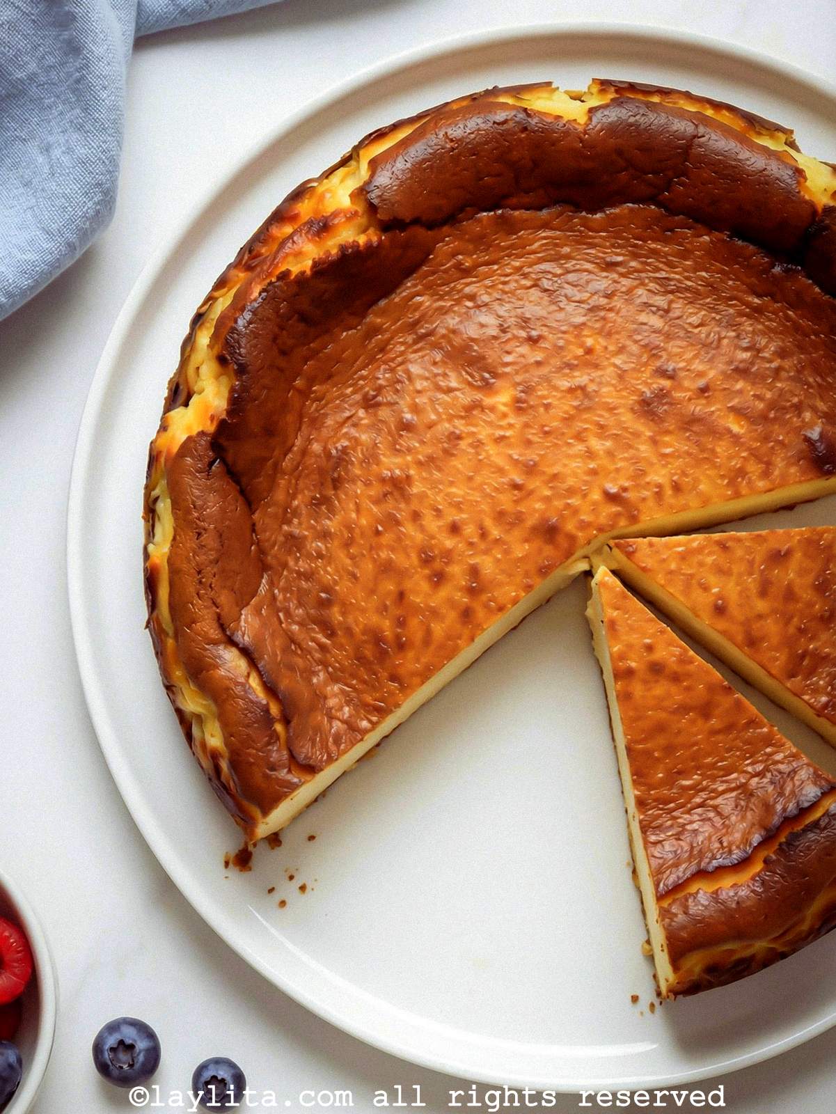 Overhead view of a cheesecake with a slice missing