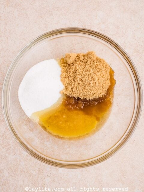 In a large mixing bowl whisk together the oil, applesauce, sugar, and brown sugar together until well combined.