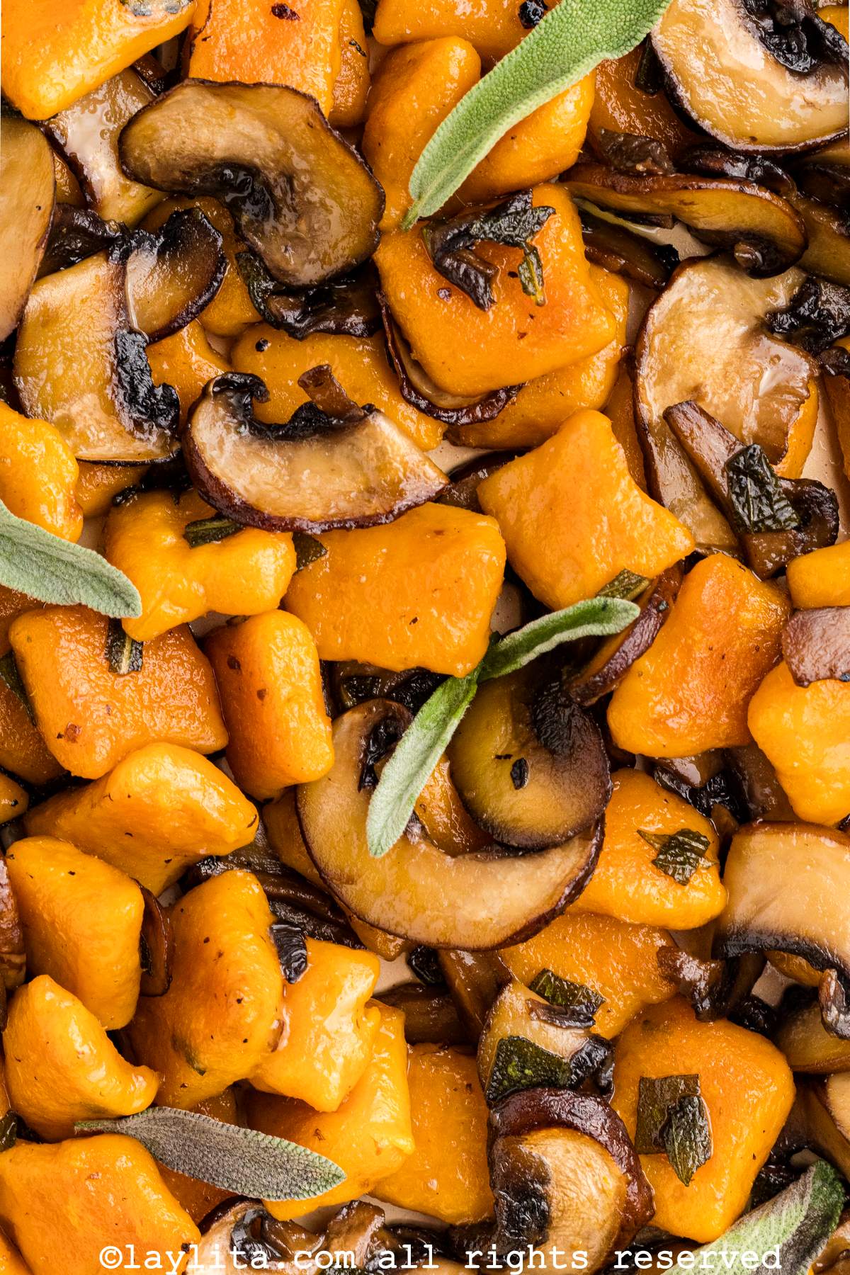 Closeup of sweet potato gnocchi with a mushroom sage butter sauce