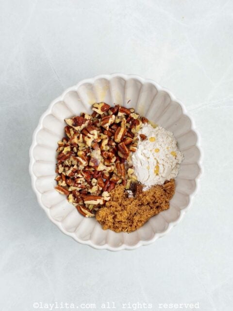 Chopped pecans, flour, brown sugar, melted butter in a small bowl