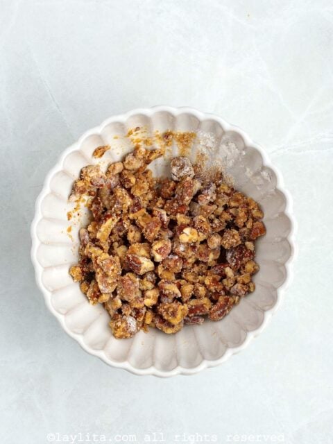 Chopped pecans, flour, brown sugar, melted butter in a small bowl after being mixed