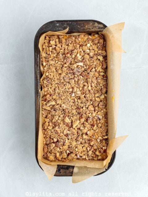 An unbaked sweet potato loaf cake with pecan streusel topping
