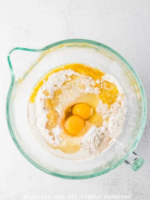 Add the eggs, milk, melted butter, vanilla, and applesauce to the bowl and mix with an electric mixer until combined.