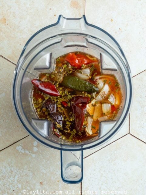Ingredients for red chile sauce in a blender before blending