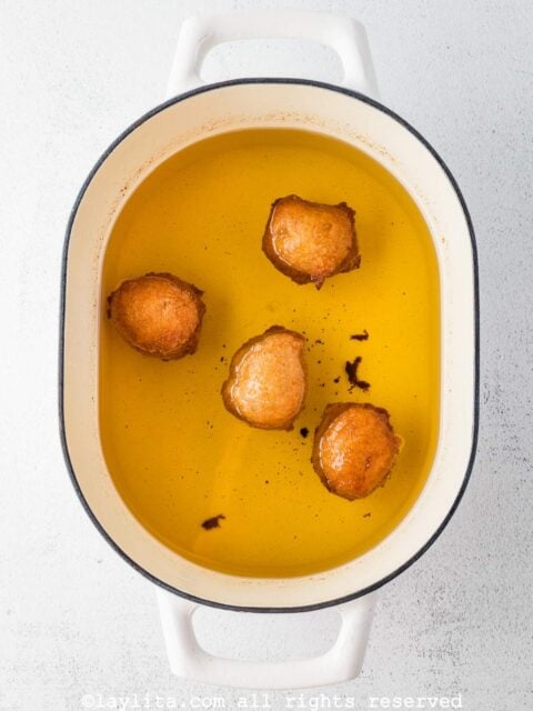 Apple fritters cooking in oil