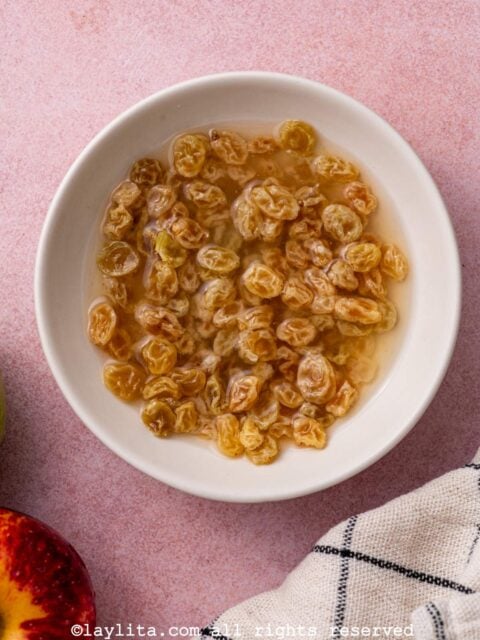 Golden raisins soaking in hot water