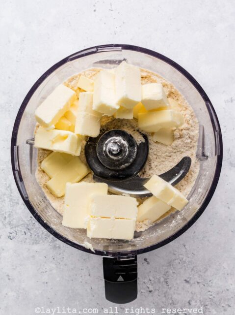 Add the butter and pulse until small crumbles form. The mixture will look like parmesan cheese at first, but keep pulsing until the crumbles are more like small pebbles.