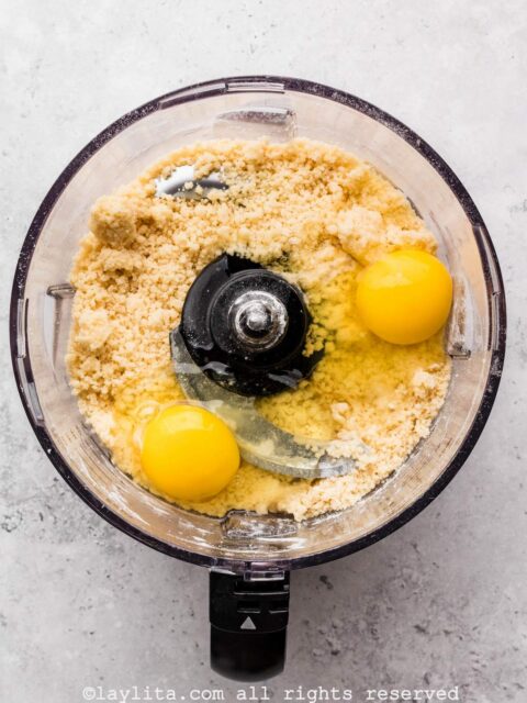 Add the eggs and continue to pulse until the dough forms a ball and starts to clean to the sides of the bowl.