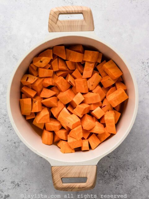 In a large pot over medium heat, add the sweet potatoes and juice.
